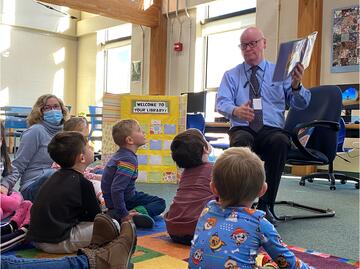 Dr. Morris reading to Preschool students
