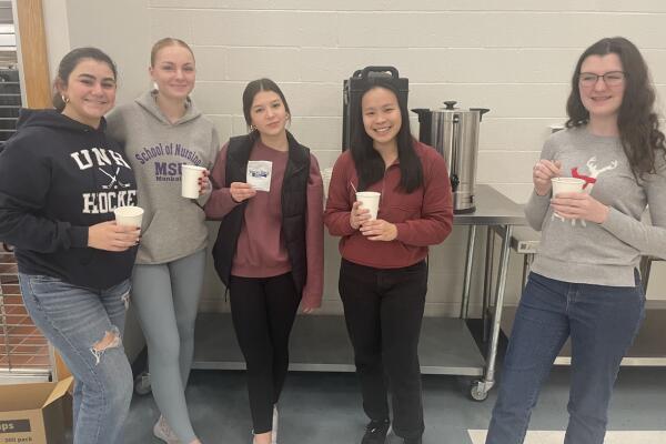 High schools students enjoying a cup of cocoa.