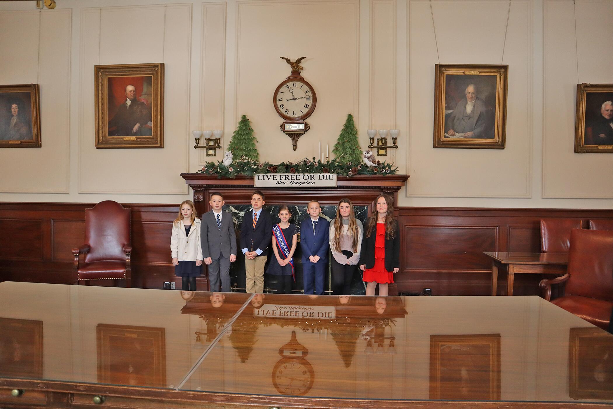 Parker Fleming, Levi Wilson, Jack Rugg, Eleanore Lively, Noah Sanders, Zoey Hill and Hattie Hammill at the New Hampshire State House on Jan. 9. (Photo courtesy Oyster River Cooperative School District)