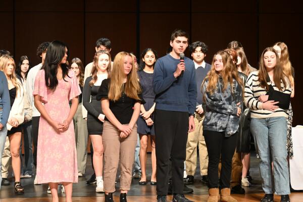 A group of high school students on stage during the Scholastic Arts Ceremony at Pinkerton Academy.