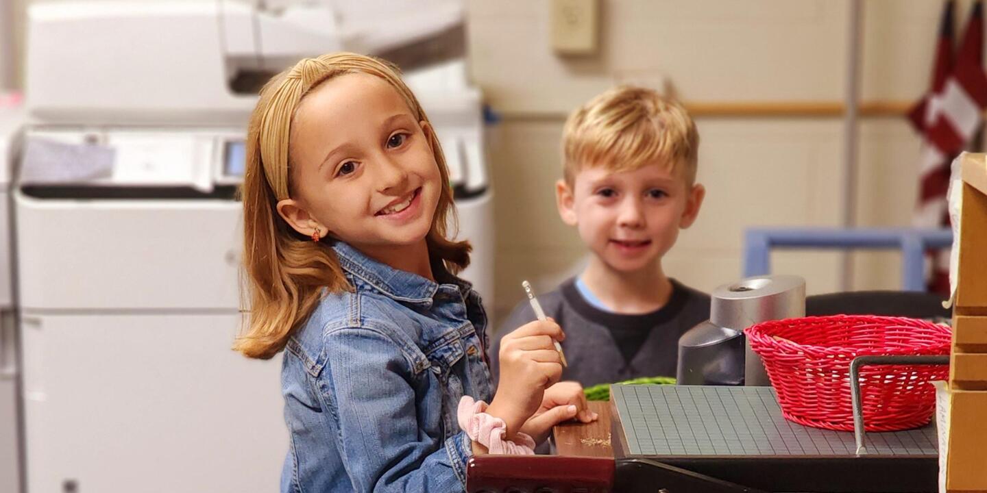 A boy and a girl helping in the school office