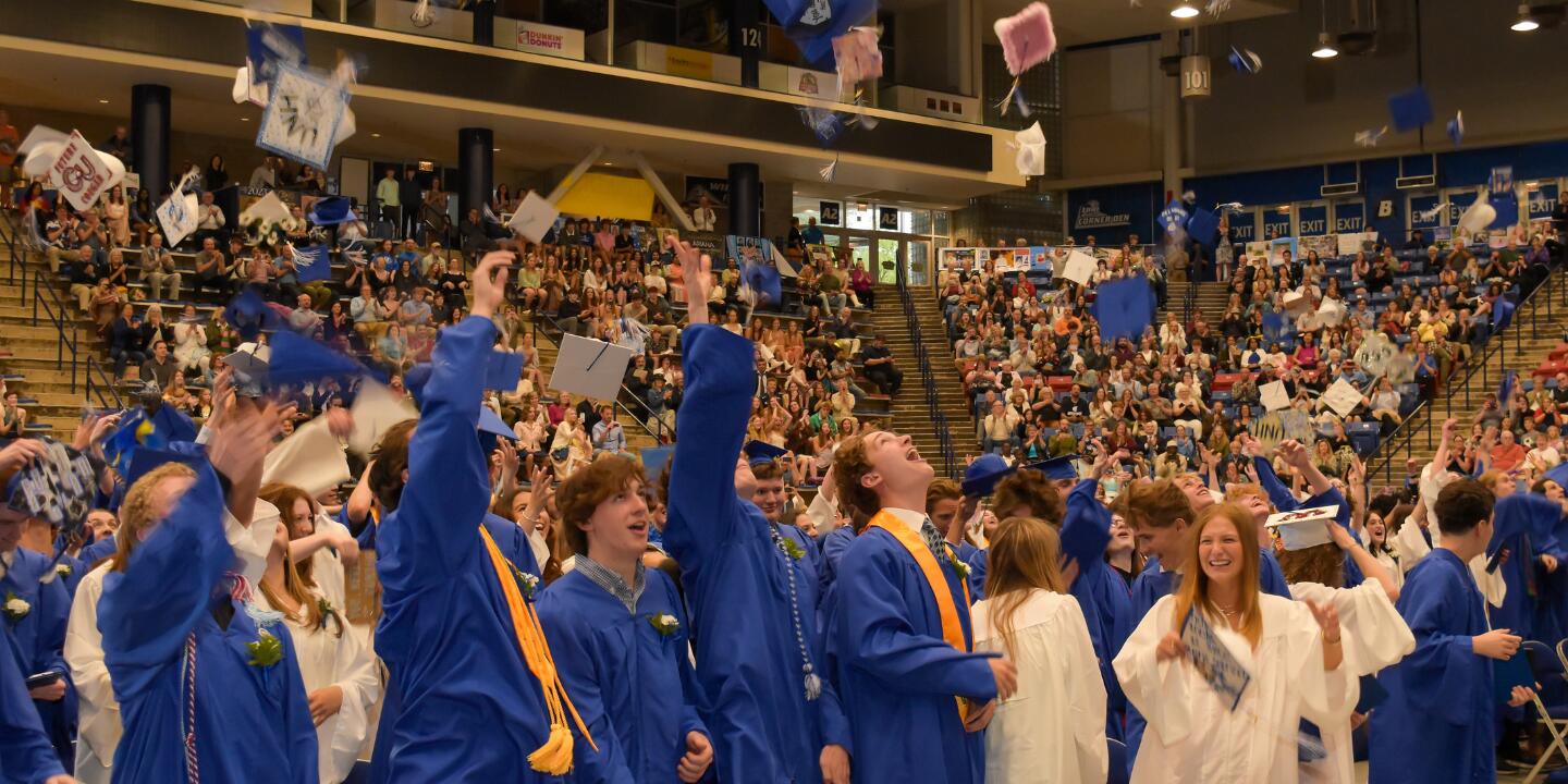 image of several members of the class of 2023 during cap toss at the end of the graduation ceremony